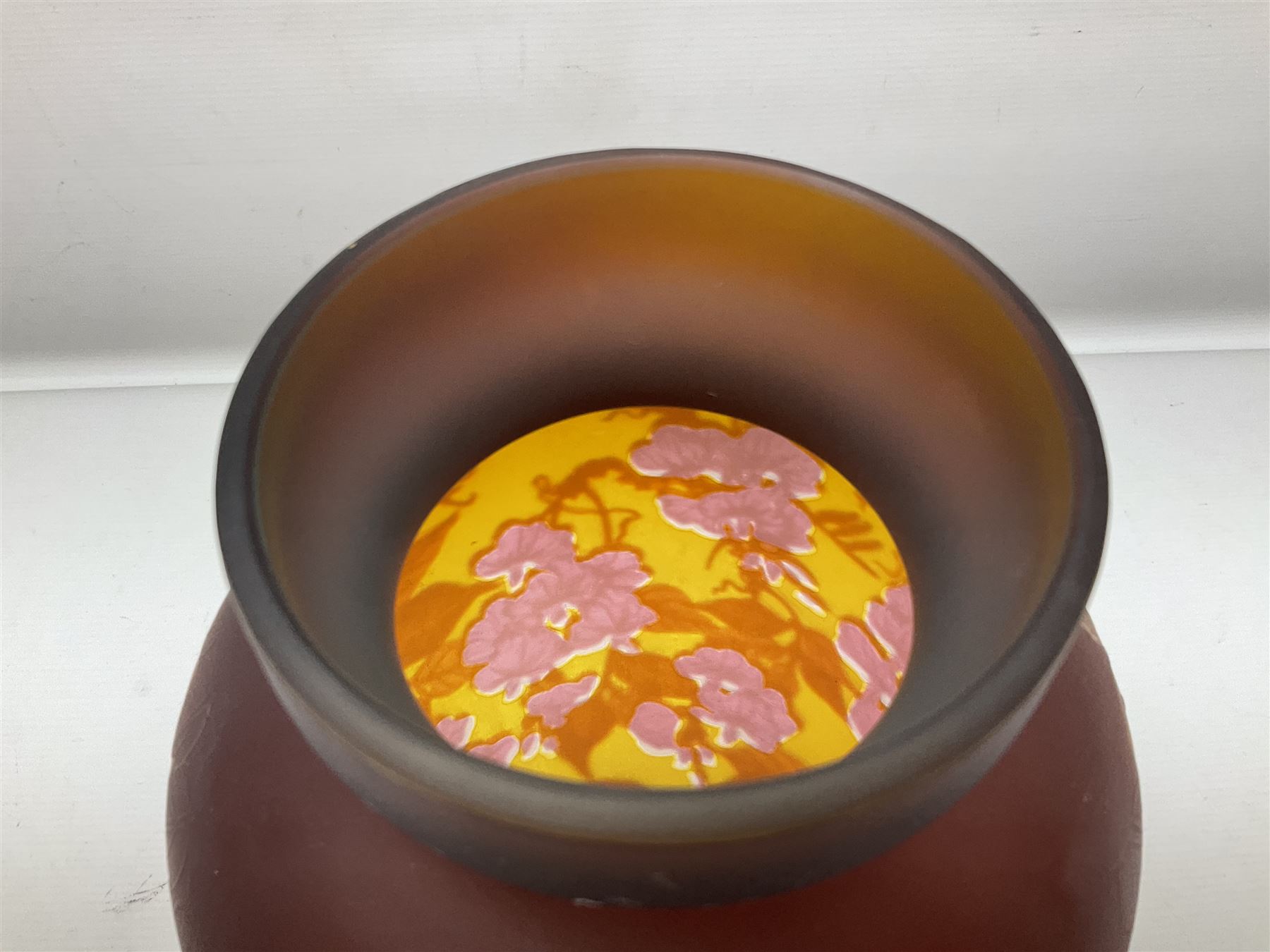 Art Nouveau style glass vase, in the style of Galle, the tapering body decorated with trailing red and pink foliage on a yellow ground, H33cm
