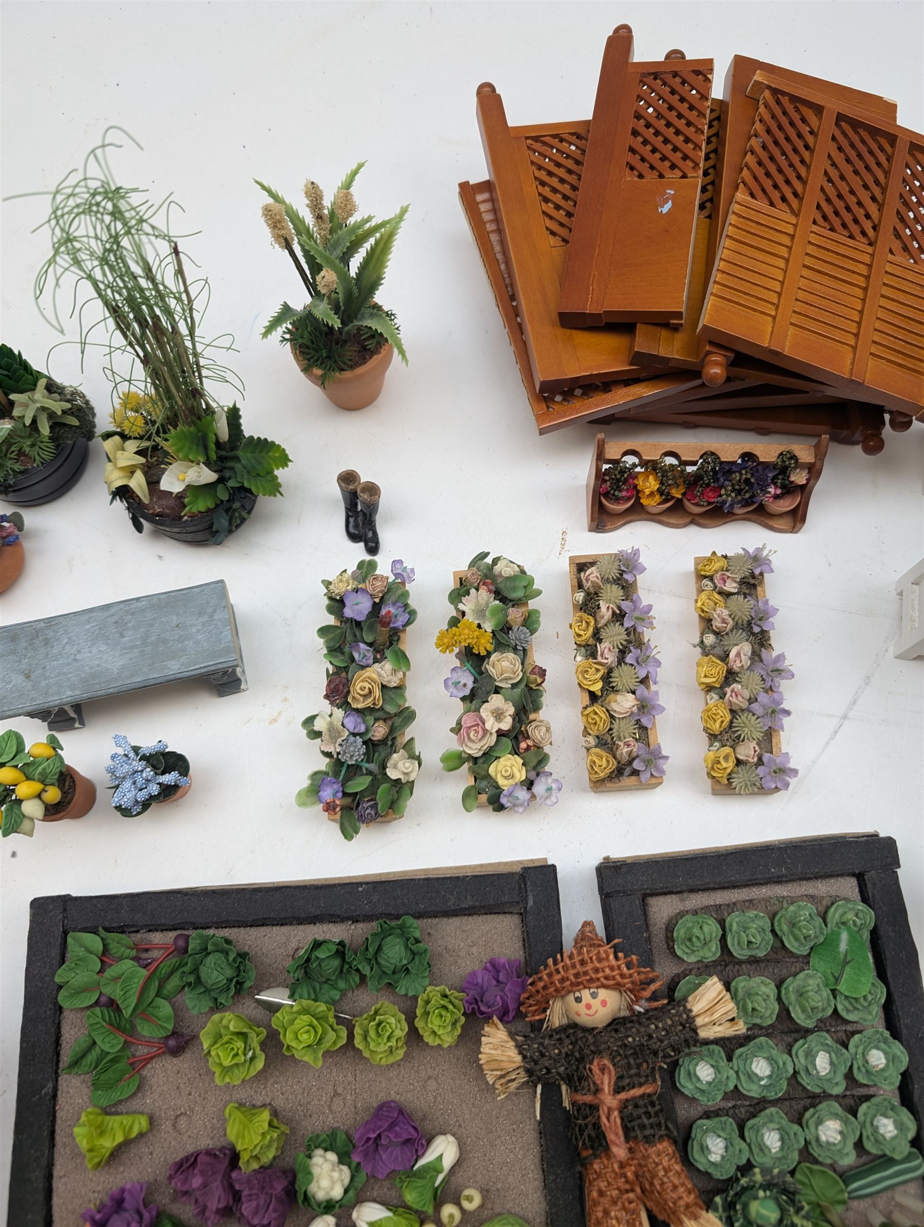 1:12 scale dolls house allotment and garden accessories, including wooden shed on a stone effect base, two vegetable patches, terracotta plant pots with flowers and foliage, stone effect plant pots, other planters, loose sunflowers, scarecrow, rabbit hutch, garden tools, fencing panels, etc 