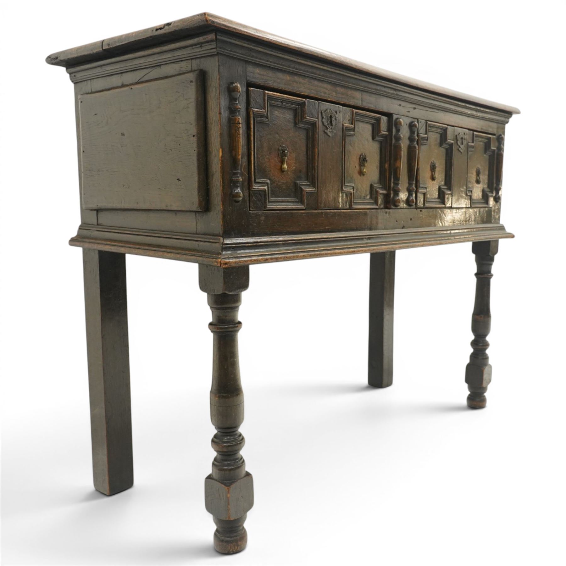 Georgian oak dresser base, plank top above an arrangement of two fielded panel drawers with moulded geometric fronts, on turned front supports and block rear legs