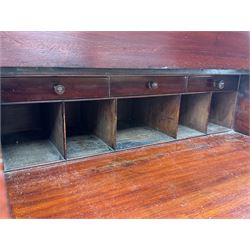 Large Victorian mahogany Registry/Dickens’ desk, spindle gallery top, one side with five small drawers and the other with blind cupboard drawer, revealing pigeon holes with scroll carved locking side bars on either side, above a hinged and leathered writing slope with three drawers and pigeon holes underneath, above a central locking drawer with key, the pedestals each with four drawers and  turned knob handles, separates into four parts for transport
