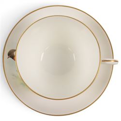 Royal Worcester large novelty cup and saucer, each hand pained, the cup with grouse, the saucer with stonechat