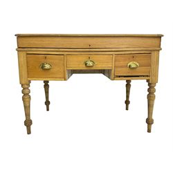 Early 20th century light oak kneehole desk, rectangular hinged top, fitted with frieze drawer flanked by two deep drawers, raised on ring turned supports