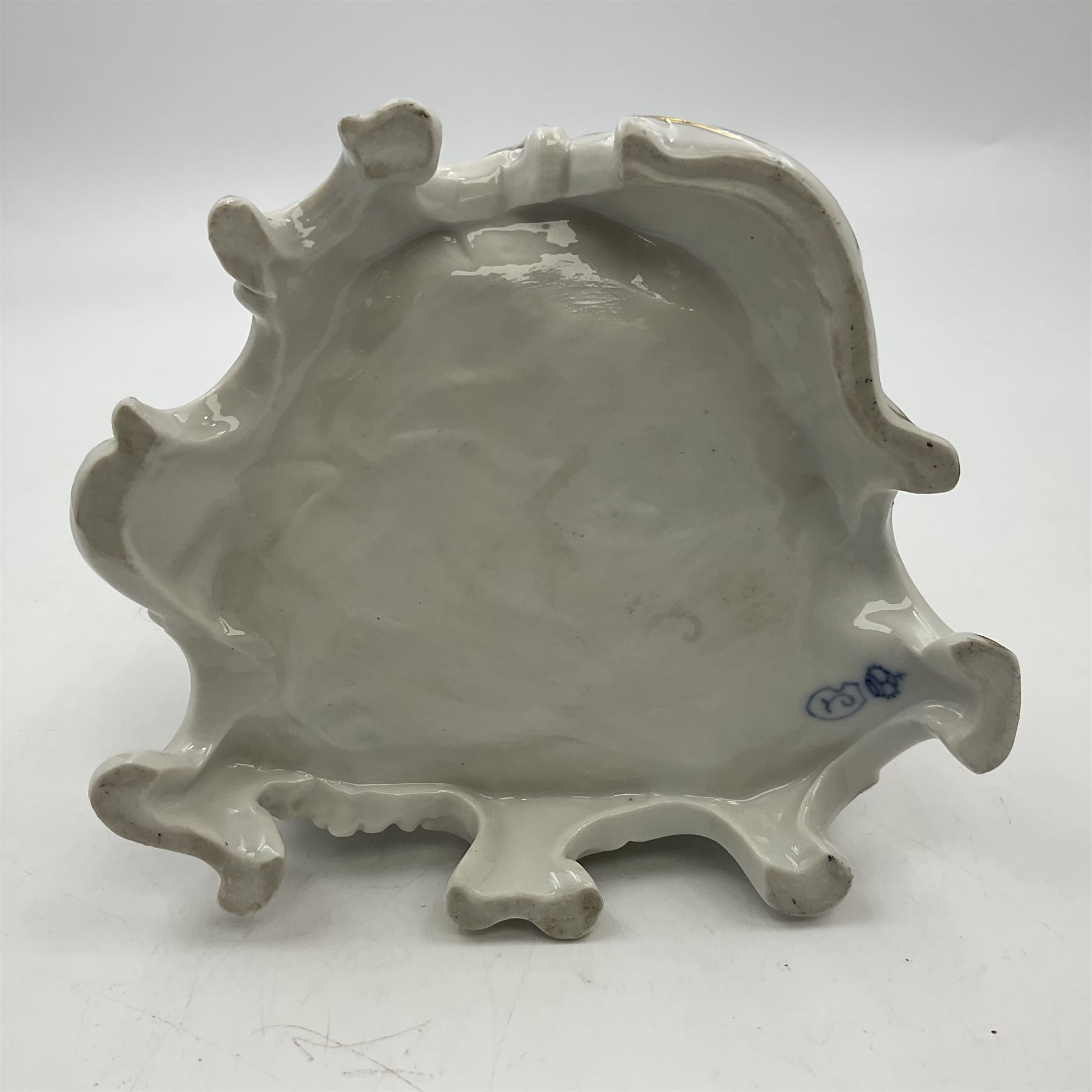 Figure group, probably Volkstedt, modelled as a courting couple seated before a table, the ornate bench and table conforming with and leading from the gilt heightened scrolling base, with blue painted mark beneath, H14.5cm
