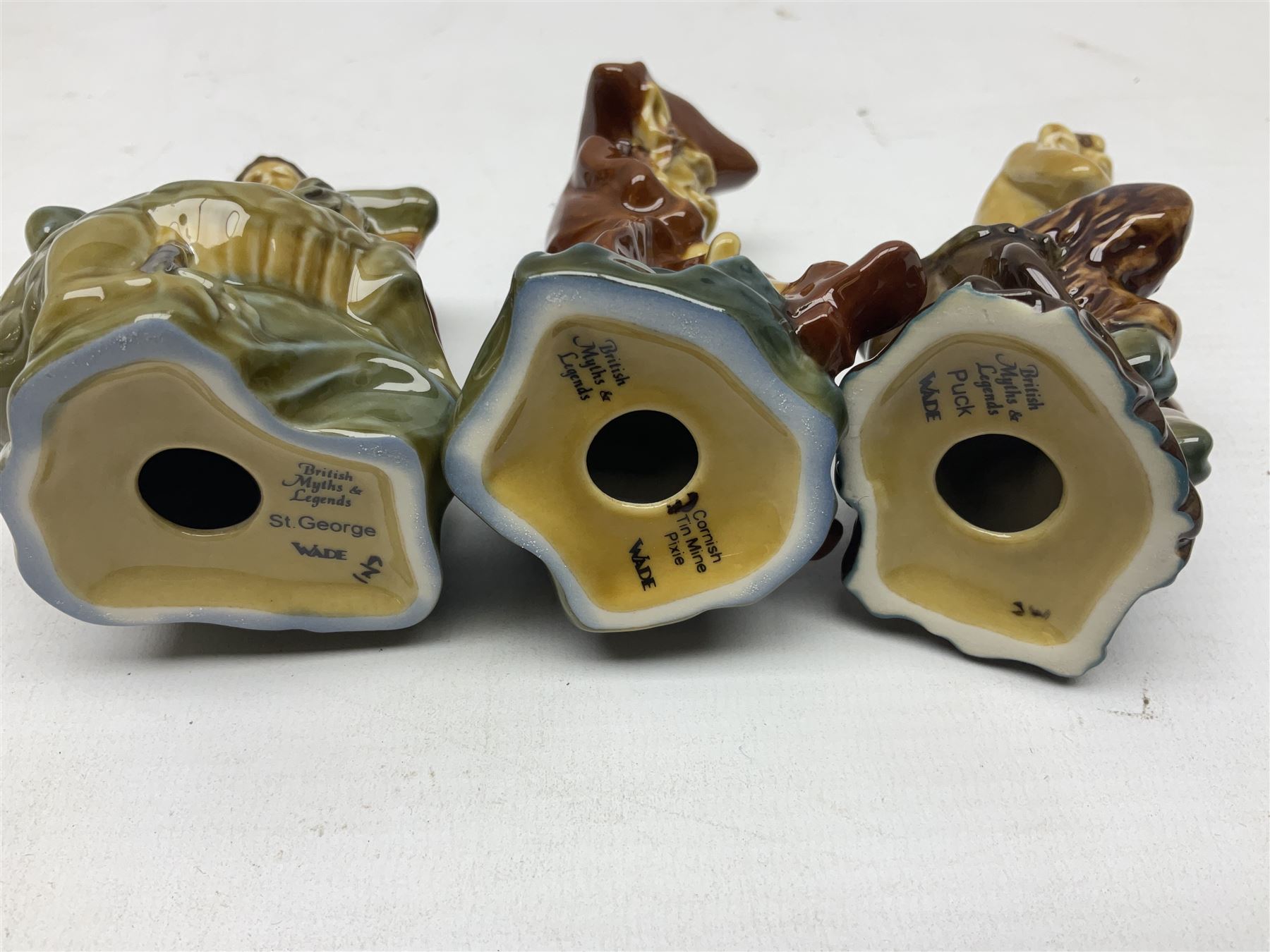 Nine Wade Collectables figures, comprising six Myths and Legends; King Canute, Mermaid, St George, Cornish Tin Mine Pixie, Puck and Green man, together with Lamb, Elephant and bear, a Wade Panda money box and two boxes of Wade Christmas Crackers