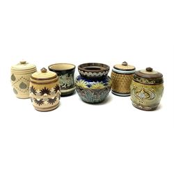 A group of Doulton Lambeth and Royal Doulton tobacco jars, to include examples with relief moulded foliate decoration, each with impressed marks and markers monograms beneath. 