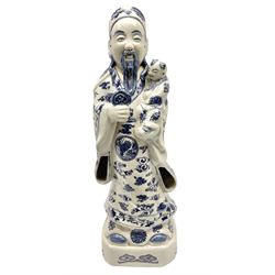 Tall Chinese temple figure of the immortal Fu Xing (Fuxing), the blue and white bearded God modelled in court dress robes cradling a child in one arm and a ruyi-sceptre in the other, with four character seal mark beneath, H52cm