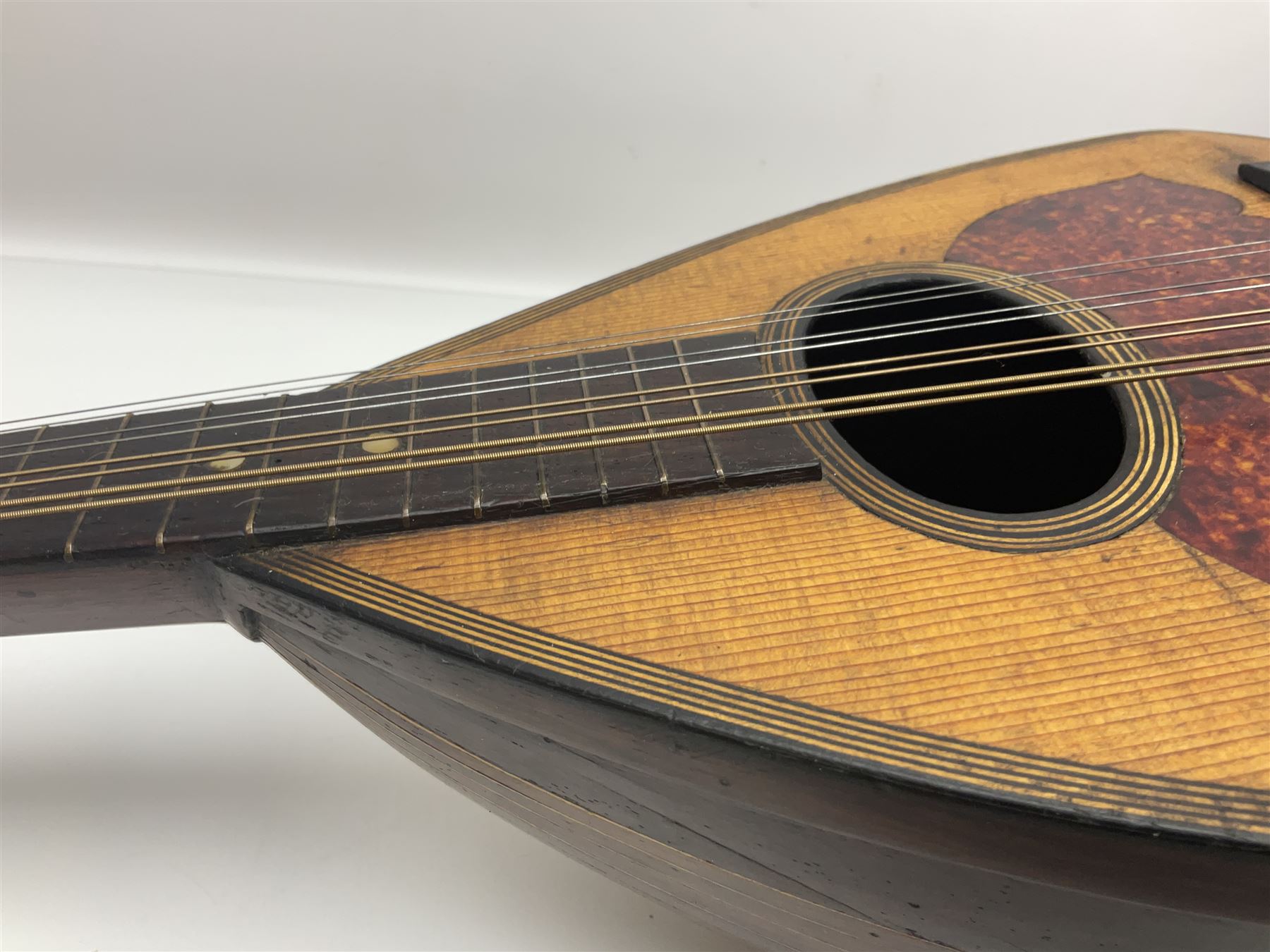 Late 19th century Italian lute back mandolin with segmented bowl back, bears label Gennaro Maglioni Napoli L61cm; in ebonised wooden case; together with another similar damaged Italian lute back mandolin for restoration or spares (2)
