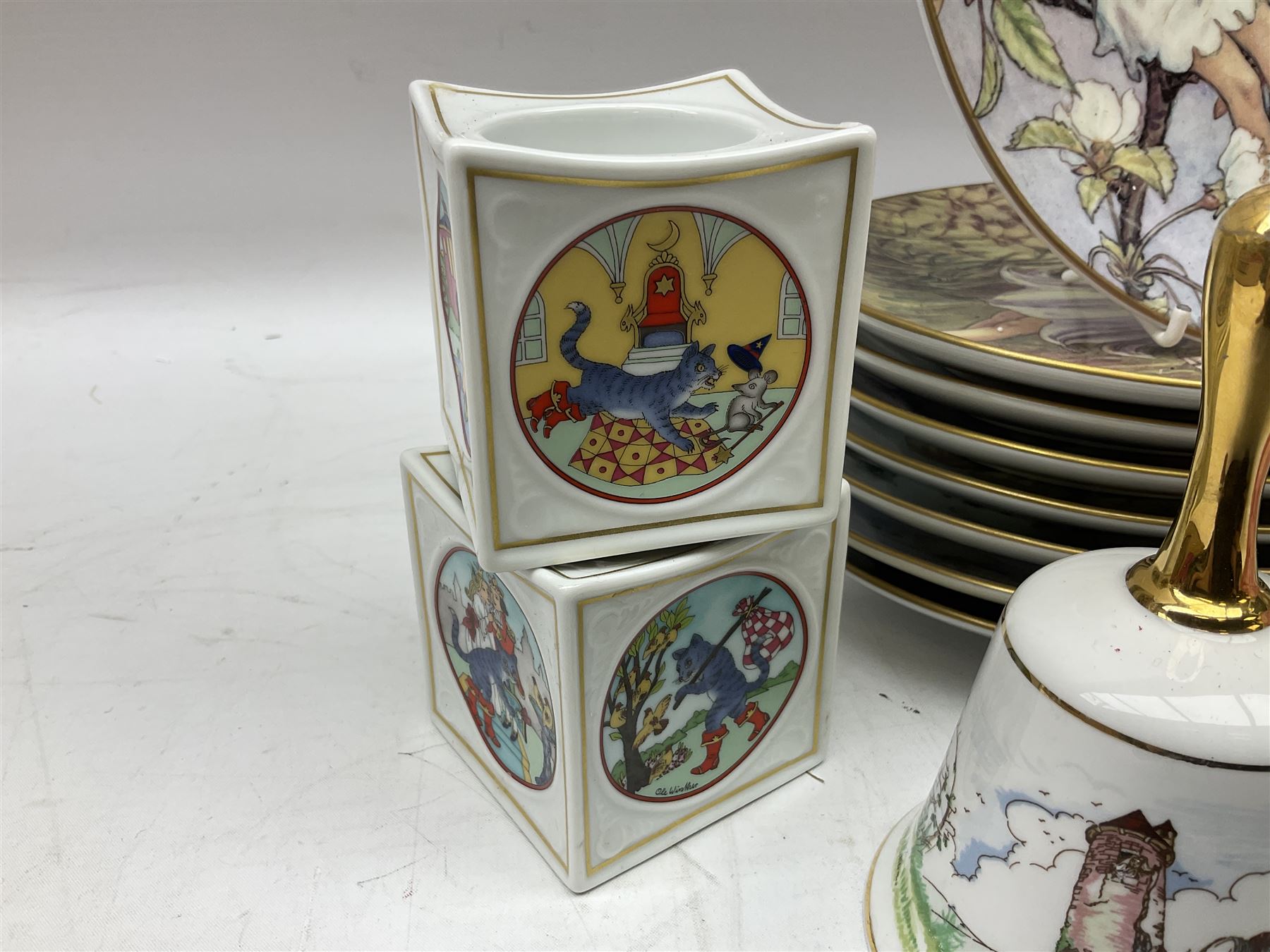 Royal Worcester Flower Fairies oval collectors plates, Goebel mustard pot, two Danbury Mint Fairy Tale bells, and pair of Hutschenreuther candlesticks decorated with scenes of Puss in Boots