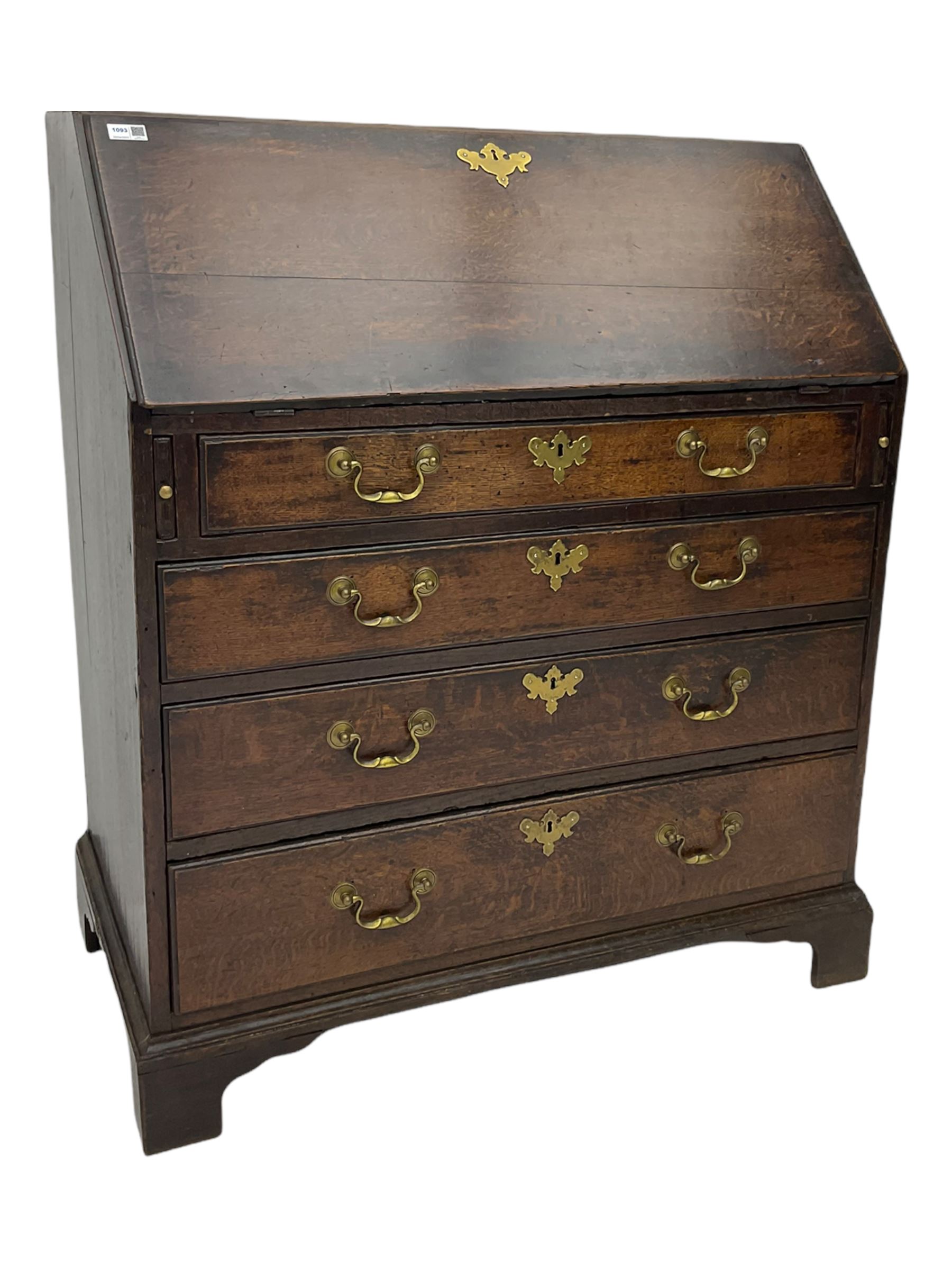 Georgian oak bureau, fall front enclosing fitted interior, four long graduating drawers, on bracket feet
