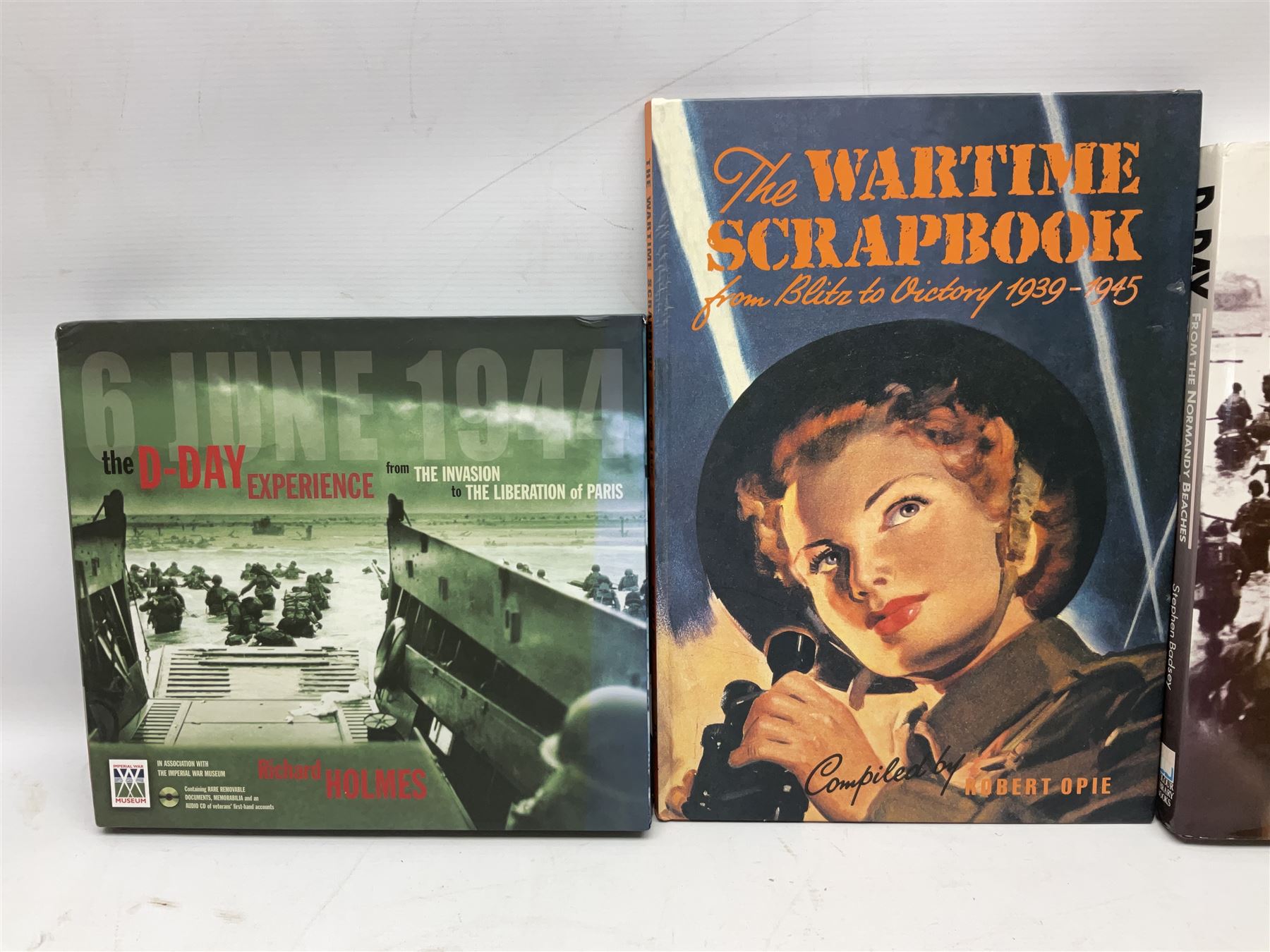 Thirty modern books of military interest including The Wartime Scrapbook 1939-1945; D-Day by Stephen Badsey; The D-Day Experience by Richard Holmes; Desert Rats by John Parker; A Most Secret Squadron by Des Curtis; Flying Colours - The Epic Story of Douglas Bader by Laddie Lucas etc; and quantity of DVDs of war and military interest