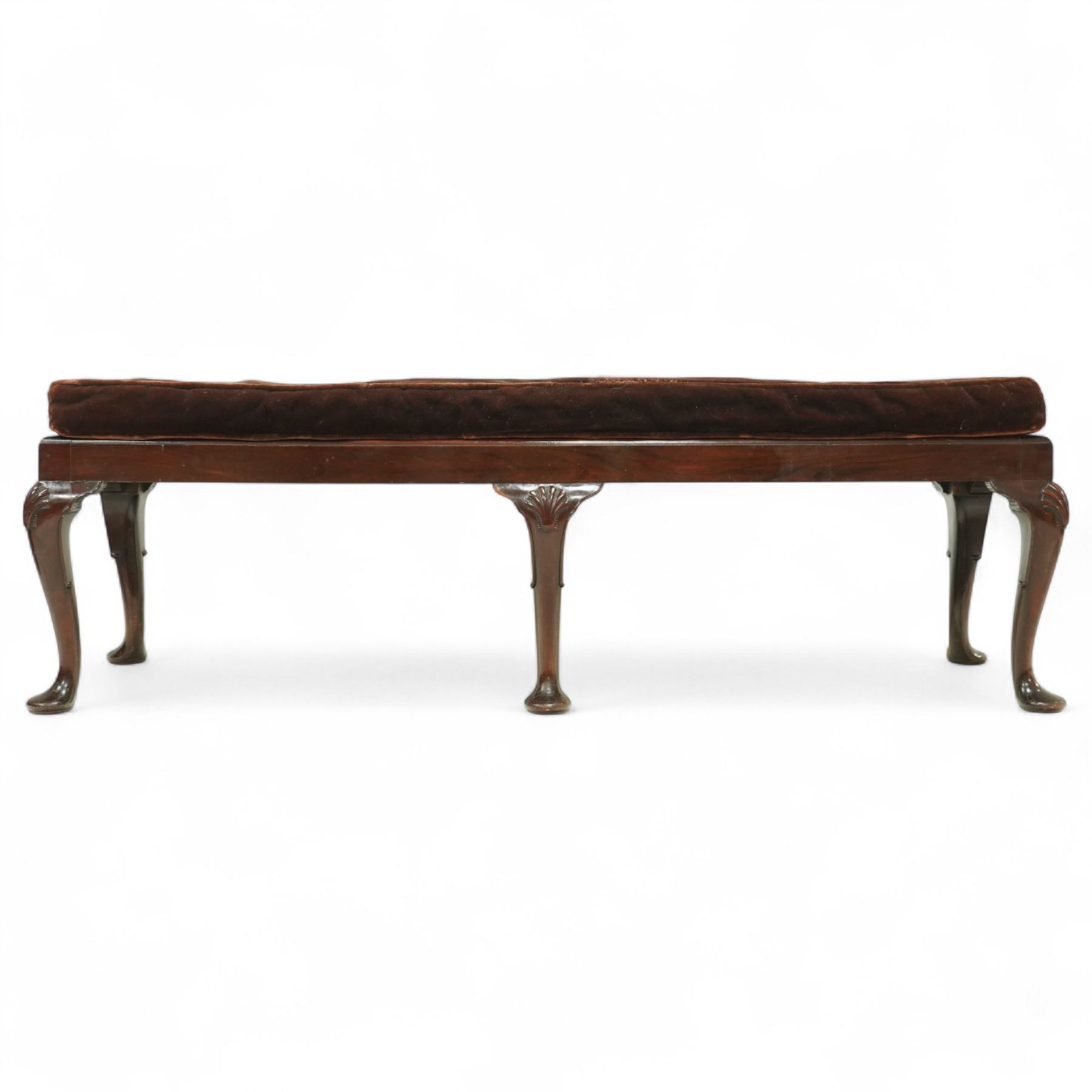 Early 20th century mahogany window seat in the George II style, with rectangular padded seat upholstered in brown velvet, raised on cabriole legs with carved shell knees and pad feet