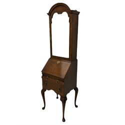 Small early 20th century Queen Anne style bookcase on bureau secretaire, the moulded arched pediment over mirrored door in shaped frame, the bureau fitted with fall front enclosing curved fitted interior, cushion moulded drawer over single drawer, on scroll and shell carved cabriole supports