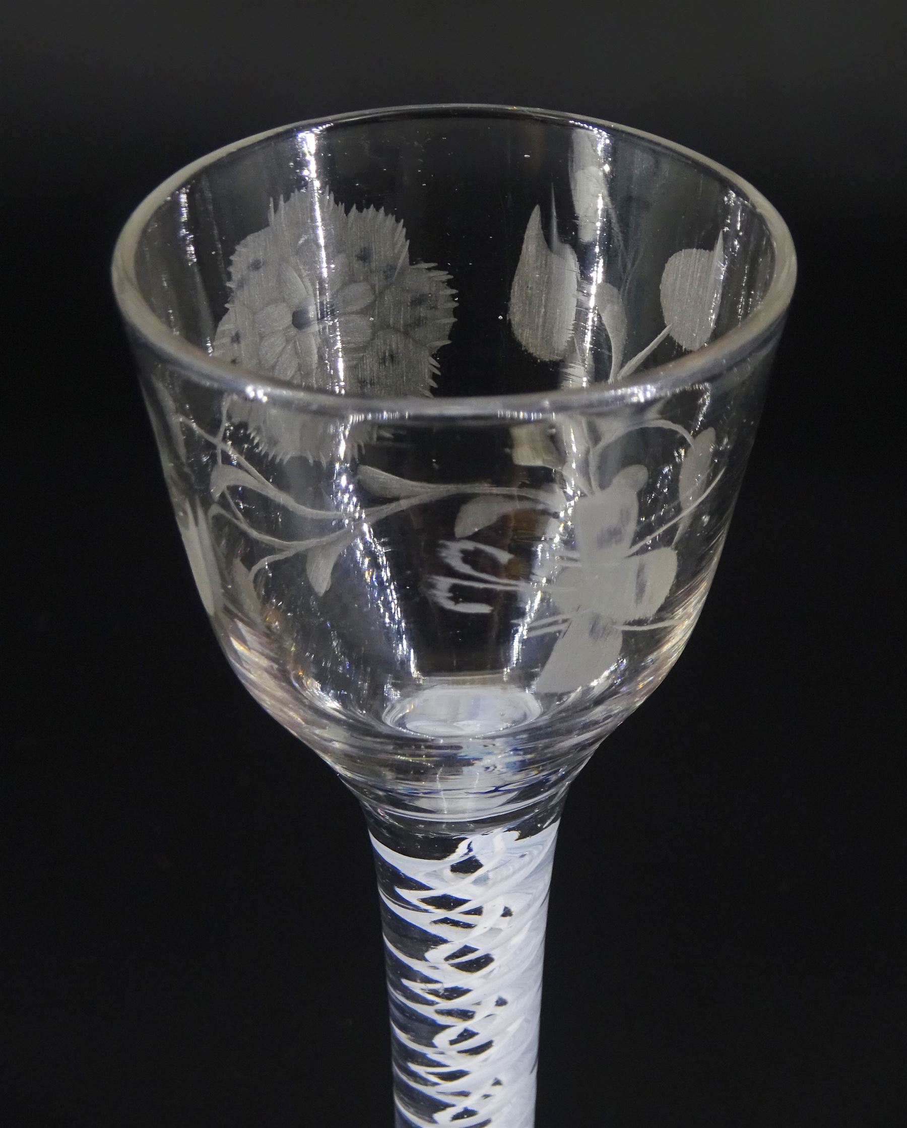 18th century drinking glass of possible Jacobite interest, the ogee bowl engraved with carnation and bee, upon a double series opaque twist stem and conical foot, H16cm