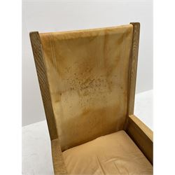 'Mouseman' oak smokers armchair, panelled sides, slung tan leather back and upholstered seat cushion, by Robert Thompson of Kilburn