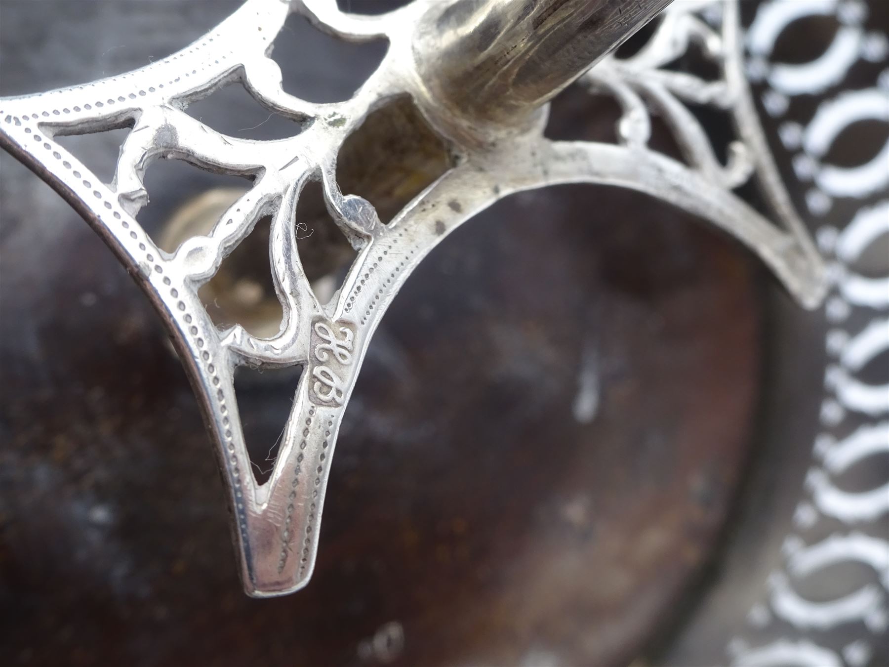 Late 18th century silver cruet stand, of oval form, with pierced sides upon four bun feet, hallmarked to handle Hester Bateman, all other hallmarks indistinct, together with five matched silver mounted cut glass cruet bottles, including some later Victorian examples, hallmarks predominantly indistinct, stand H20cm