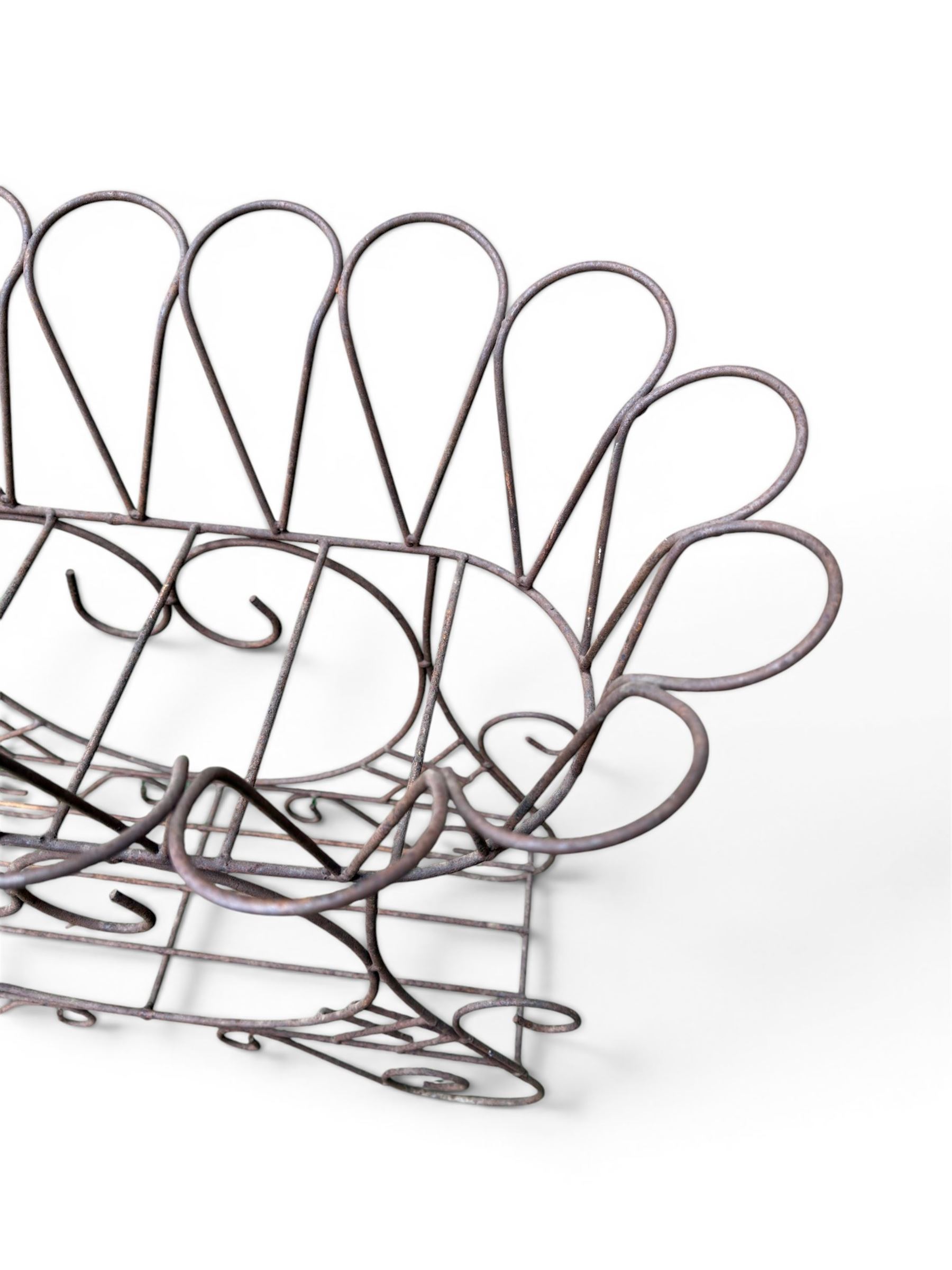 Mid-20th century wirework garden planter, oval form with heart shaped centre, under-tier shelf above scrolling feet