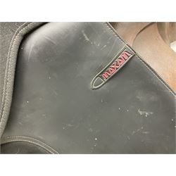 Collection of nine saddles, mainly havana leather to include a racing saddle and a Goodwin saddle, some with stirrups and leathers 