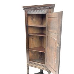 18th century and later oak corner cupboard, projecting cornice with dentil frieze, fitted with panelled cupboard door enclosing shelving, raised on turned supports and square stretchers 