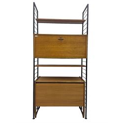 Staples Ladderax - mid-20th century teak and metal framed modular wall unit, fitted with central fall-front cupboard enclosing correspondence dividers, over secondary separate teak fall-front cupboard, adjustable shelf to top