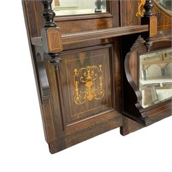 Late Victorian mirror back sideboard, the raised mirror back with four bevelled mirror panels, inlaid with scrolling leafage and floral cornucopias, the lower drop-centre base fitted with central double cupboard enclosed by bevel glazed doors, two flanking panelled cupboards with inlay and single drawer, on turned feet