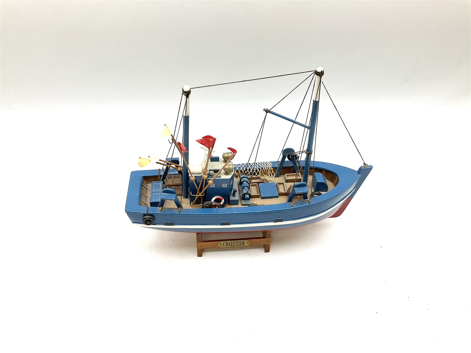 Wooden model of RMS Titanic, on a fixed black stand bearing plaque inscribed 'Titanic 1912', L54cm, H22cm, together with model of a sloop, gaff rigged on stand bearing plaque inscribed 'Sloop' L32cm, H42cm; and model of a fishing trawler on a stand bearing plaque inscribed 'Chalutier' L35cm, H28cm (3)