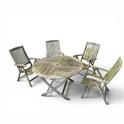 Five piece teak garden dining set, comprising circular folding table and four folding armchairs, with slatted seats and backs in a weathered finish