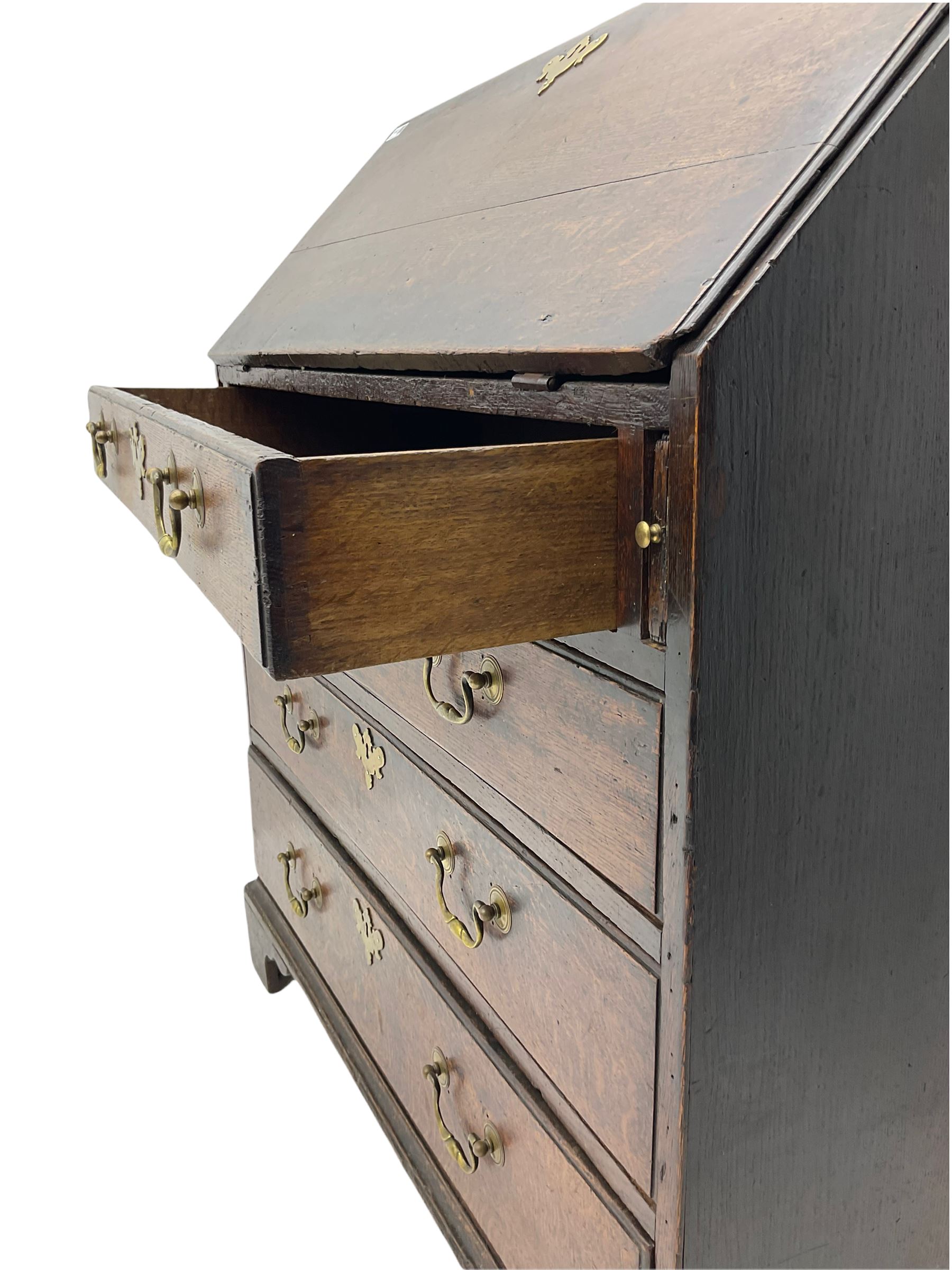 Georgian oak bureau, fall front enclosing fitted interior, four long graduating drawers, on bracket feet