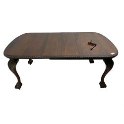 Early 20th century Georgian design mahogany extending dining table, rectangular top with rounded corners and gadrooned edge, moulded frieze rail over cabriole supports with acanthus carved knees and ball and claw feet, on castors, with additional leaf
