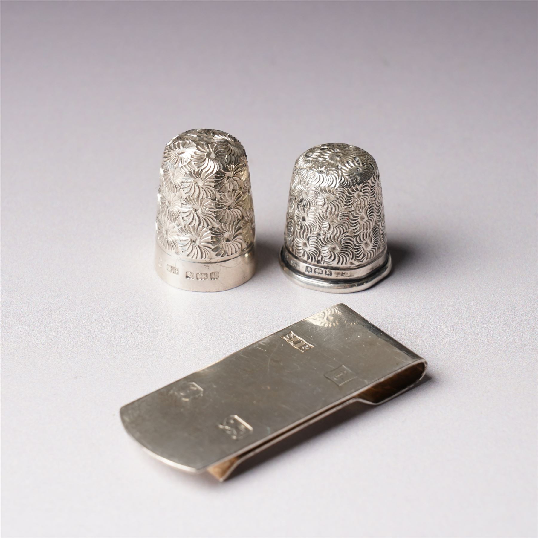 Small silver pepper mill H7cm London 1987,  small silver baluster measure, silver egg cup, two thimbles and a silver note clip
