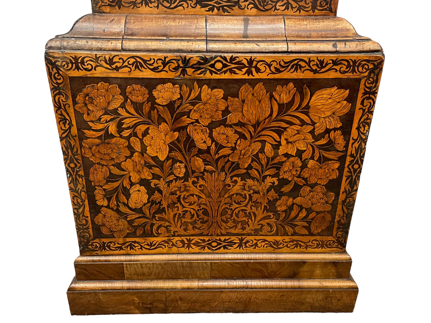 William & Mary floral marquetry 8-day longcase clock c 1700, later mid-18th century four pillar rack striking movement with a square brass dial and subsidiary seconds dial, ringed winding holes and calendar aperture to the matted dial centre, with London cherub head cast spandrels and (later) fretted steel hands, silvered Roman numeral chapter ring with stylised fleur di Lis half hour makers, narrow Arabic five-minutes, minute track and inner quarter hour track, signed Thomas Horlock, Hammersmith, 
case with box upstand to the domed floral marquetry decorated caddy with three brass flame finials, above a moulded cornice and fretwork frieze,  inlaid hood door with attached barley twist pillars to the front above an inlaid convex moulding, full length D moulded trunk door with a circular lenticle inlaid with floral and foliage panels inhabited with birds, on a conforming marquetry plinth with applied double skirting. Thomas Horlock is recorded as a Whitesmith & Clockmaker of Hammersmith, Middlesex.
A copy of Thomas Horlock's will dated the 15th June 1757 is held at The National  Archives Kew.