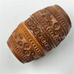 Three 19th century coquilla nut pomanders or flea catchers, two of egg shaped form and the third of barrel from with carved and pierced decoration and screw threaded join, largest H8cm