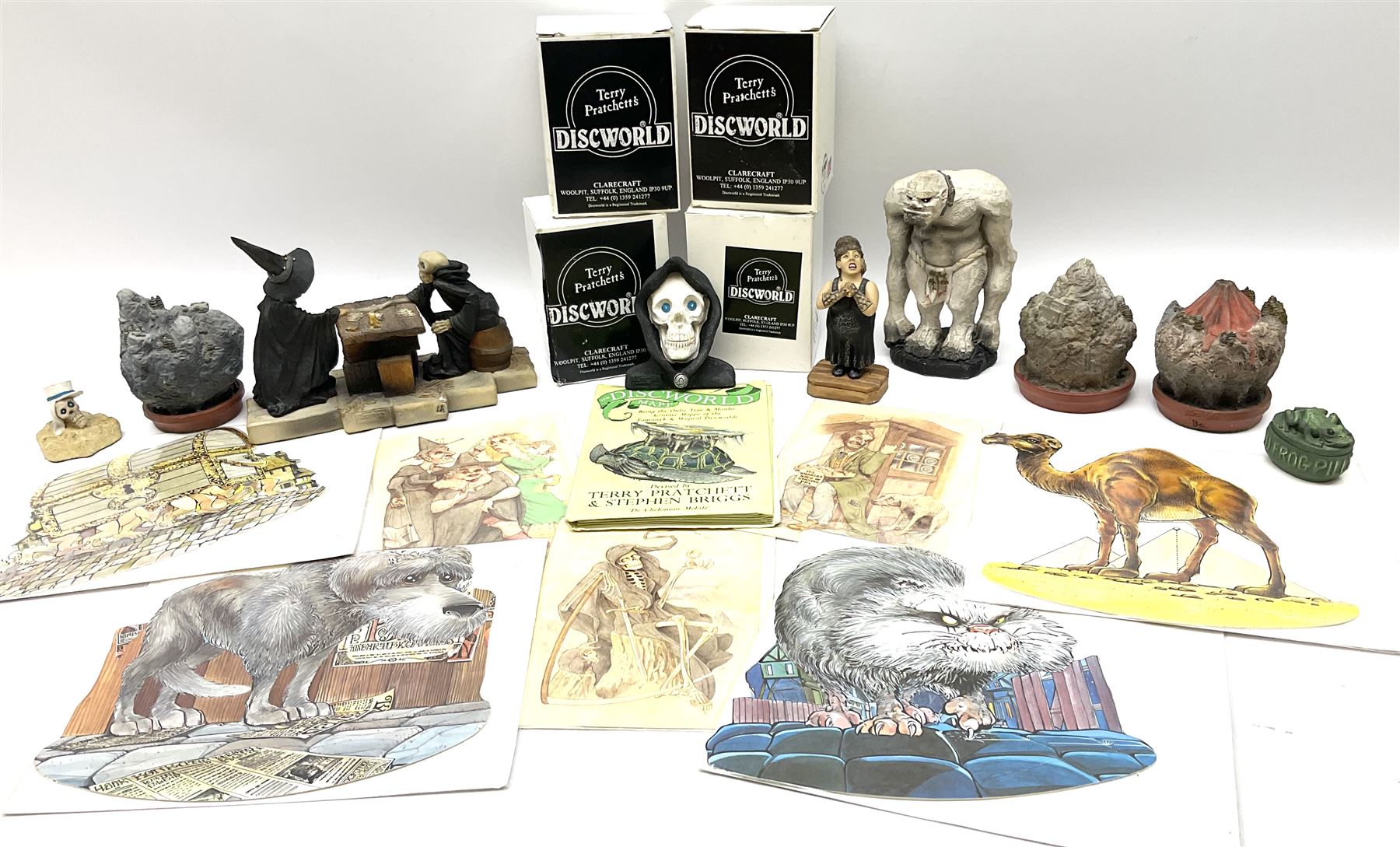Terry Pratchett Discworld figures, designed by Clarecraft, comprising Death and Granny Weatherwax, DW90, Deathhead DWE8, Dried-frog pill box, boxed, DW63, Death as Beau Nidle, boxed, DW88, Agnes Nitt DW68, Detritus, DW22, Bonsai mountain, DW78, Volcanic bonsai mountain, boxed, DW79, Bonsai mountain valley, DW80, together with the Discworld mapp, and a collection of Terry Pratchett cards.  