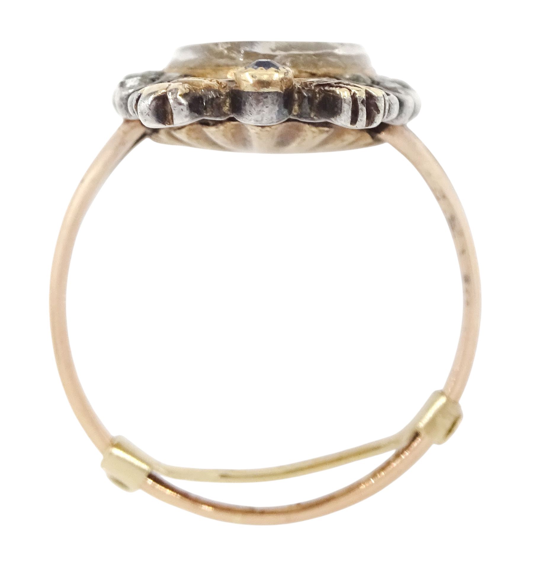 18th / 19th century silver and gold diamond and sapphire portrait ring, set with an oval miniature of a woman wearing a bonnet on ivory, under a glazed panel, surmounted with a 'trophy of love' symbol, modelled as a flaming torch and bow and quiver, set with a single round cut sapphire and rose cut diamond surround, to trifurcated shoulders, on French 18ct gold shank, Eagle hallmark. This lot has been registered for sale under Section 10 of the APHA Ivory Act