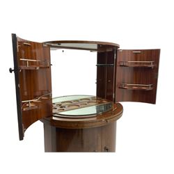 1930s Art Deco walnut demi-lune cocktail cabinet, enclosed by four curved doors, the upper section with mirrored interior, glass shelf and glass holders, the lower section fitted with shelves and bottle holders