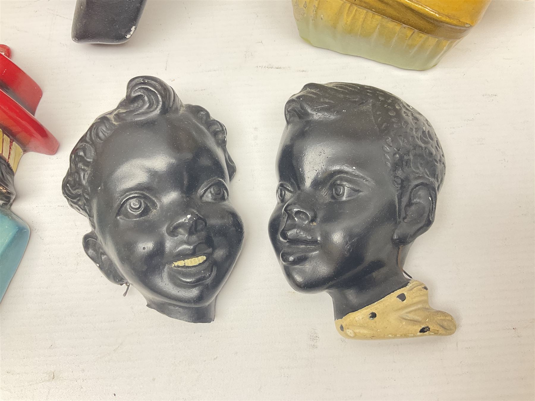 Art Deco plaster female bust, marked Arnova 353, together with a collection of wall masks 