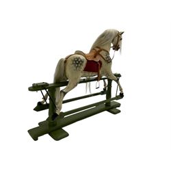 Attributed to F. H. Ayres - early 20th century carved wooden dapple grey rocking horse, with leather saddle and tack, with glass eyes, on green painted trestle base with turned column supports