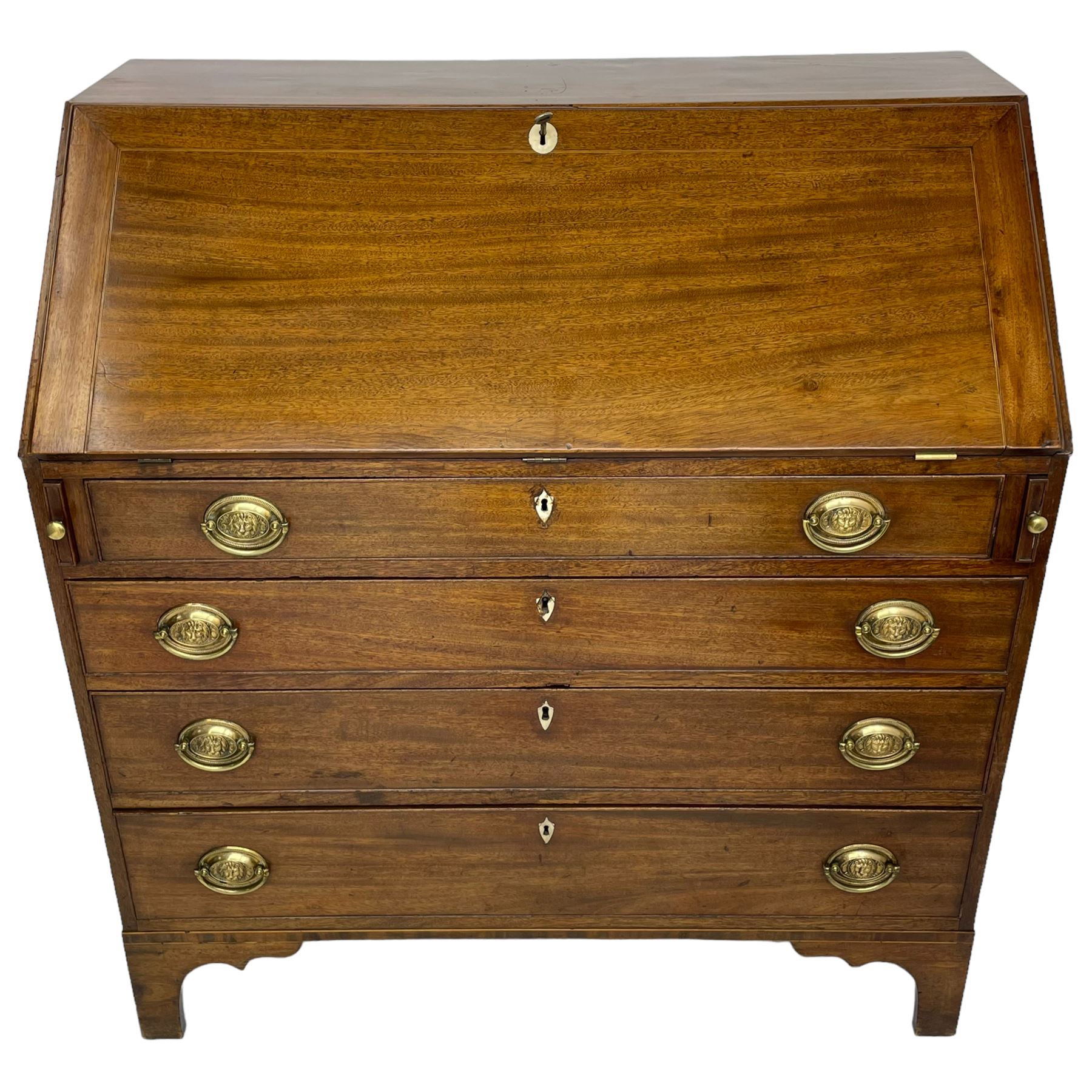 George III mahogany bureau, the fall-front banded and with boxwood stringing, enclosing fitted interior with pigeonholes and drawers surrounding a central cupboard with inlaid shell motif, the base with four graduating cock-beaded drawers, each with pressed brass handle plates with central lion masks and ivory escutcheons, on shaped bracket feet
This item has been registered for sale under Section 10 of the APHA Ivory Act
