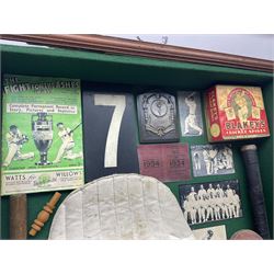 Four framed sporting memorabilia displays, the largest example containing 1930s cricket memorabilia, together with two fishing displays and a football display, each within wooden glazed frames, largest H105cm