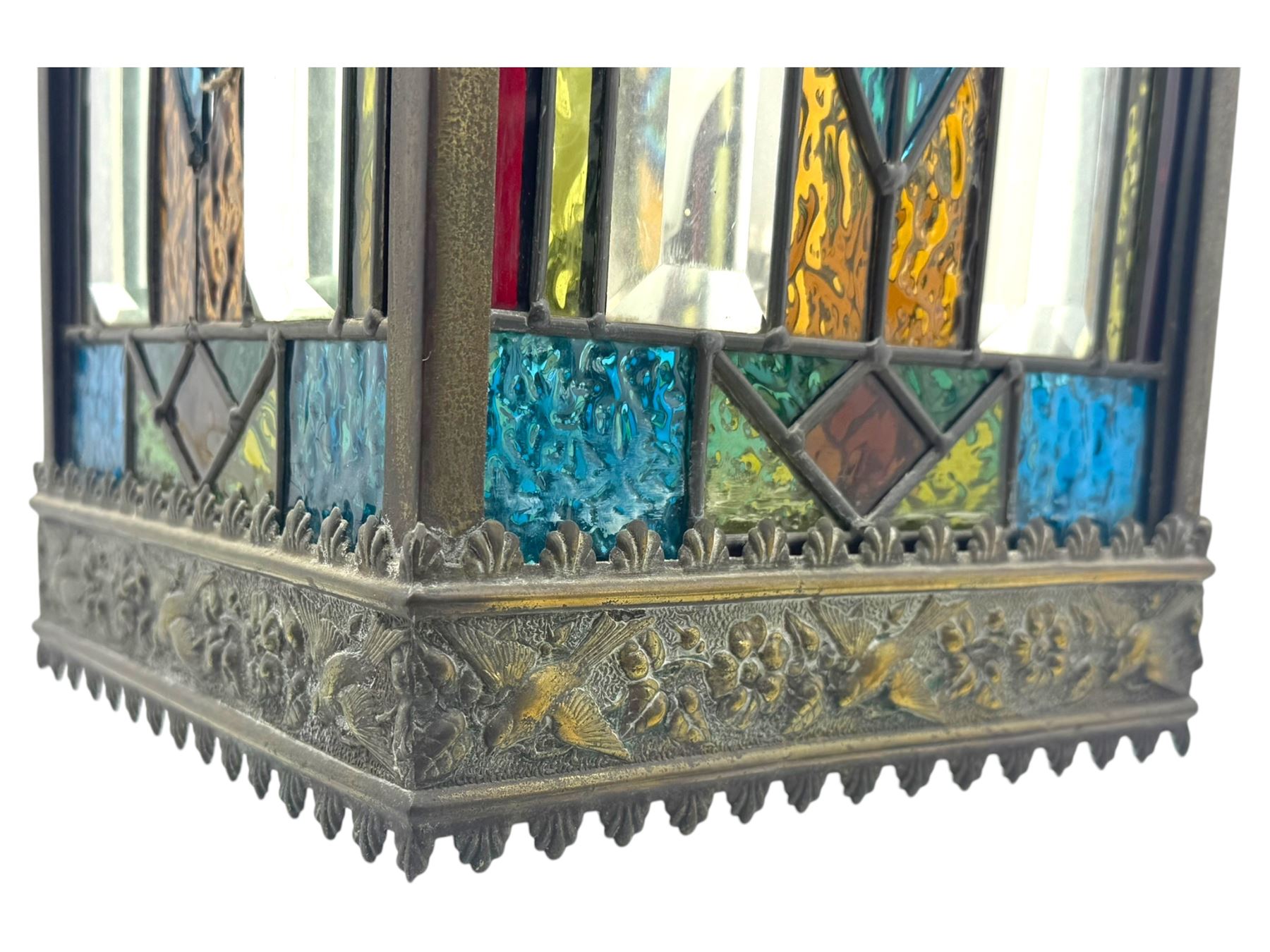 20th century Gothic design stained glass and brass hall lantern, with ornately decorated frieze and apron, with geometric coloured glass panels and eight rectangular bevelled glass panels, with bell shade, wired for electricity 