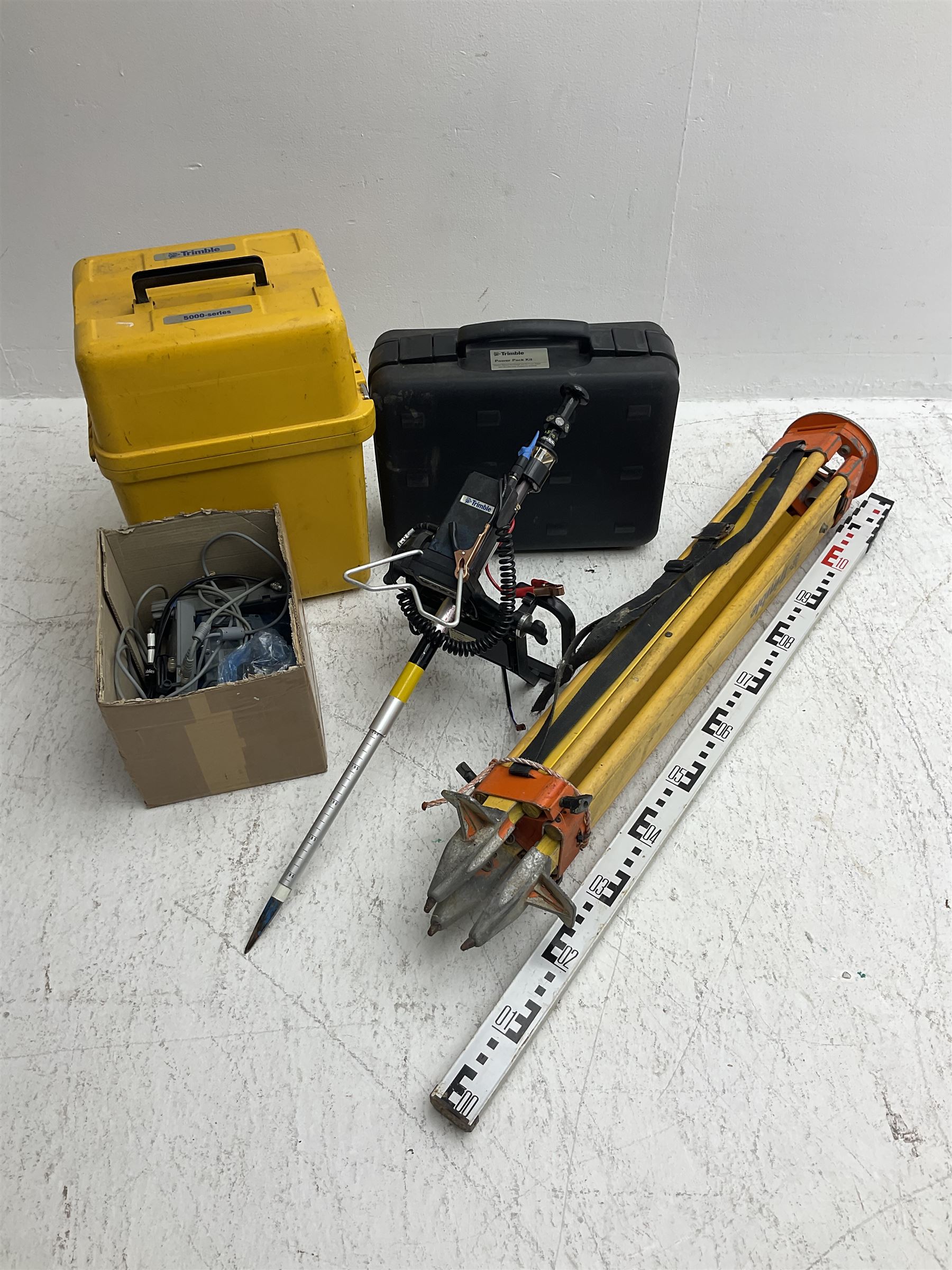 Trimble land surveying equipment - 5000 Series 5603 DR300+ Robotic Reflectorless Total Station, serial no.84310406; in carrying case; together with GPS Holder 58317019, serial no.95320184; ACU 571225500, serial no.83214786; Docking Station 58252019, serial no.95823458 with Power Supply; RMT 606 Remote Target on pole with CU Holder and External Georadio 2.4GHz; cased Power Pack Kit; folding tripod; and aluminium 5m telescopic measuring staff