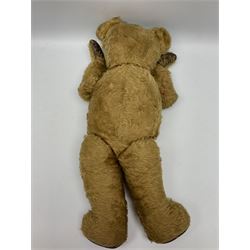 Mid-20th century plush covered teddy bear the revolving head with applied eyes, vertically stitched nose and jointed limbs with rexine pads H58cm; together with a leather backpack (2)