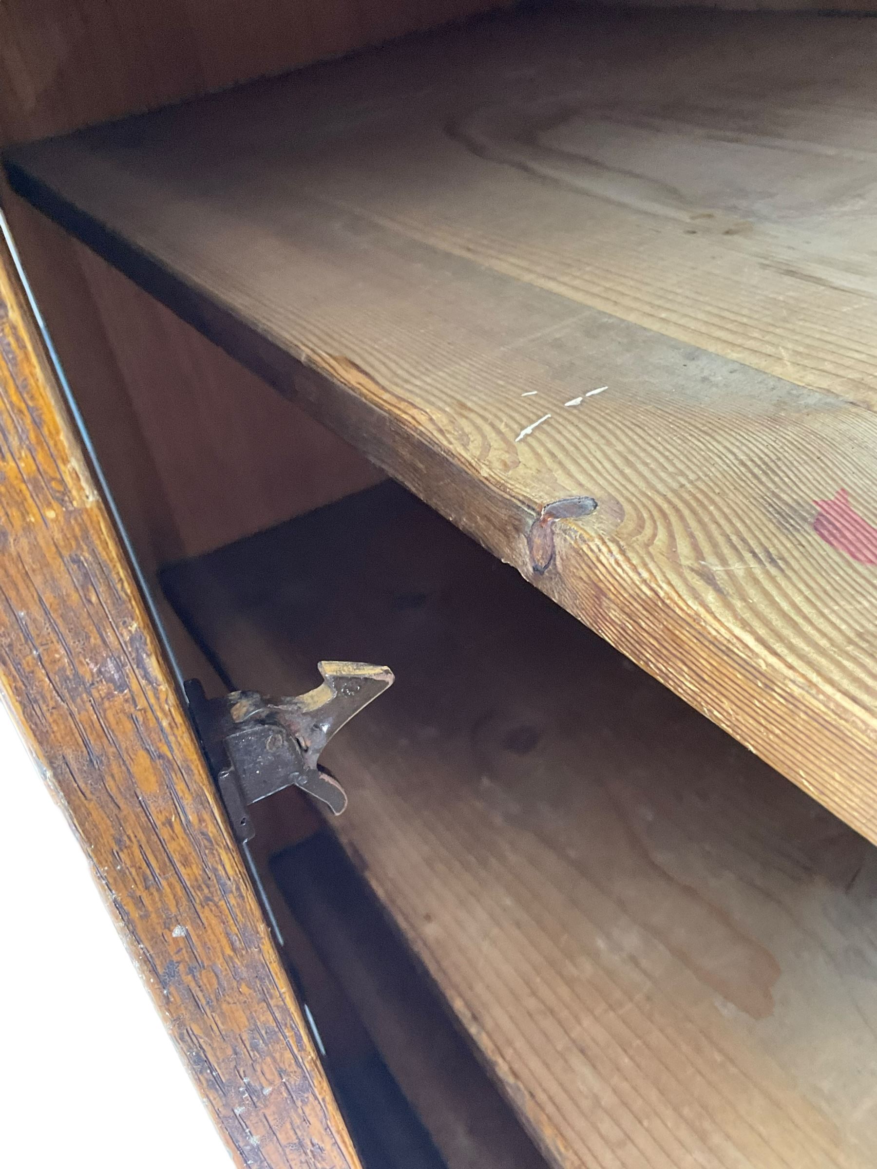 The North of England School Furnishing Company Limited Darlington - early 20th century oak school cupboard, projecting moulded cornice over two panelled doors, fitted with shelves, on chamfered plinth base 