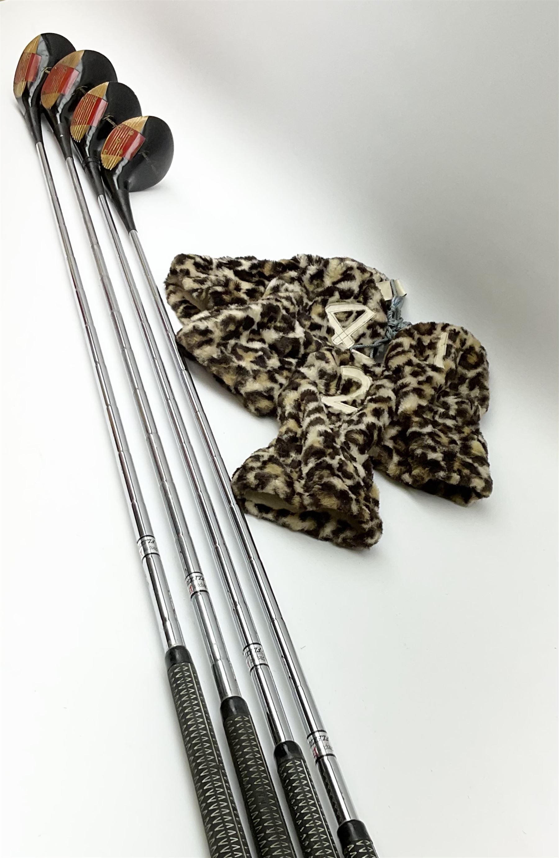 Golf - three early 20th century hickory shafted irons marked R. Simpson, Harrods Ltd etc; child's wooden shafted putter; two transitional wood grain steel shafted irons, one marked Tom Morris; and set of four Macgregor Tommy Armour woods (10)