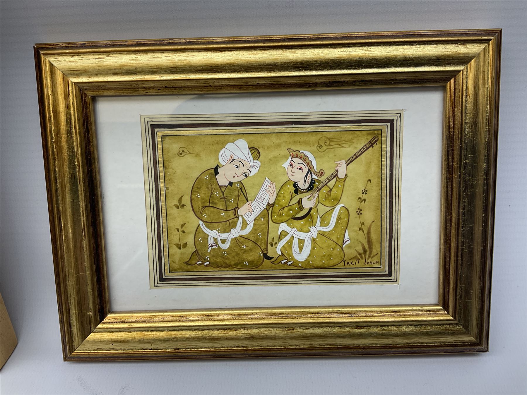 Jasur Orziev (20th century): Couple playing Sitar, miniature gouache signed; African School (20th century): Woman with Bowl on Head, sand on board signed CA together with another sand painting with hands on a globe inscribed Abaraka max 29cm x 23cm (3)