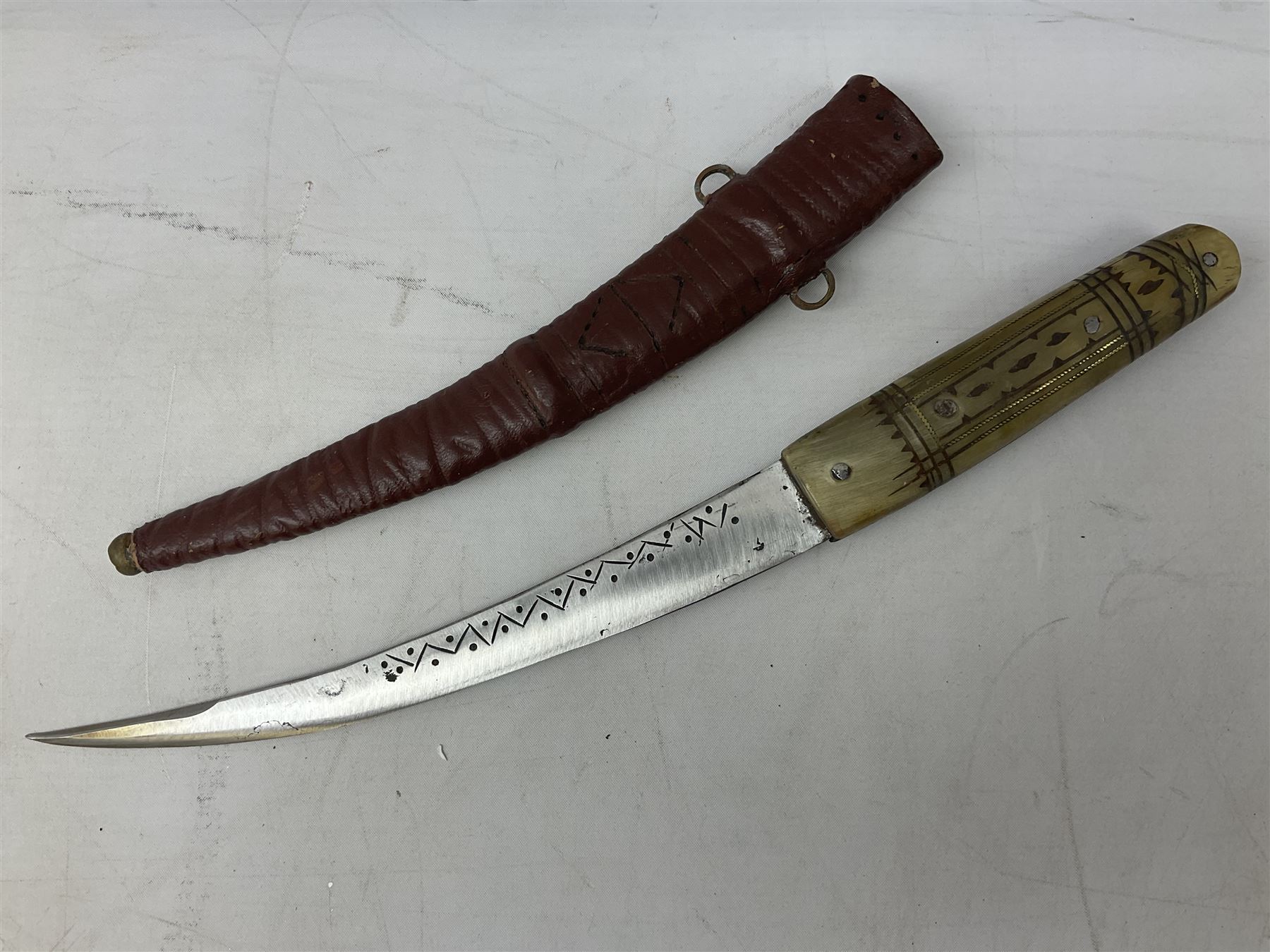 Caucasian qama or kindjal dagger, the 15cm pointed double edged blade with centre fuller and two-piece horn grip;  in nickel plated scabbard with panels of figures and script L28.5cm overall; and eastern knife with 20.5cm curving blade and decorative horn grip; in leather covered scabbard (2)