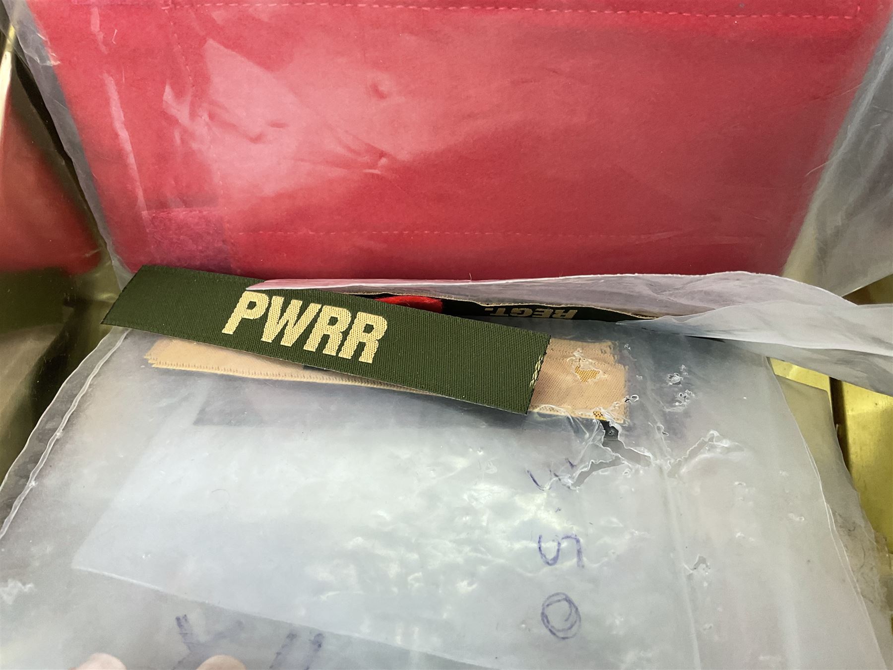 Quantity of military horse hair plumes and feather hackles, cloth stripes and regimental titles etc