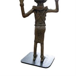 Pair of Benin bronze statures, modelled as a male and female, with armed raised, upon a square base, H76cm