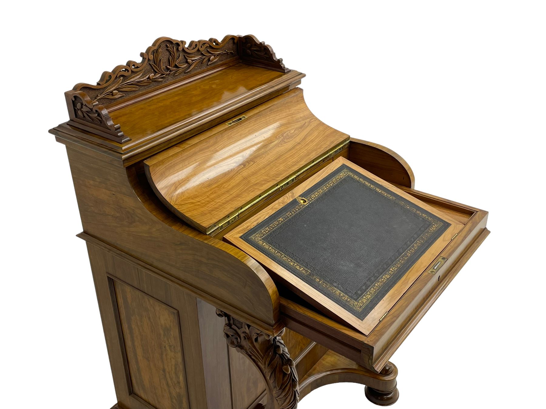 Fine and unusual 19th century olivewood piano top davenport, raised shaped back carved with olive branches and olives, the top hinges to reveal lidded and correspondence compartments, the piano lid enclosing sliding top with hinged and adjustable writing surface with leather inset, right-hand panelled door enclosing four drawers, olive branch and scroll carved cabriole front supports on moulded and shaped platform, turned cup feet with recessed castors 