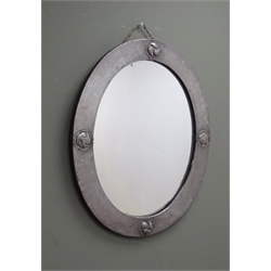  Arts & Crafts Liberty & Co. oval beaten pewter wall mirror, decorated in relief with four roundels, Liberty London plaque verso, L63.5cm x H53cm   