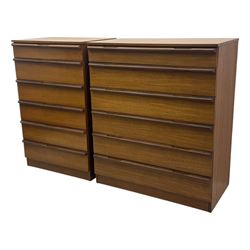 Avalon - two mid-20th century teak chests, with rectangular top above six graduated drawers, each fitted with recessed sculted pulls, raised on a flush plinth base.

(W 82cm D 55cm H 97cm)
(W 82cm D 55cm H 97cm)
